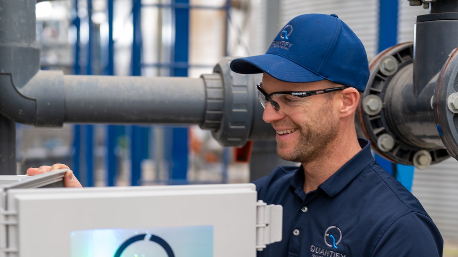 Dave Fox opening a Quantify enclosure on a pipe rack outside a plant