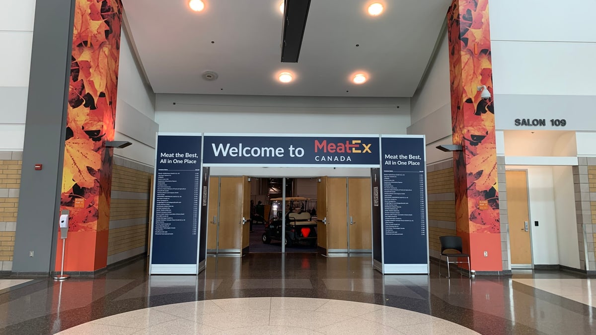 The entrance to MeatEx Canada, a welcome banner over the hall doors